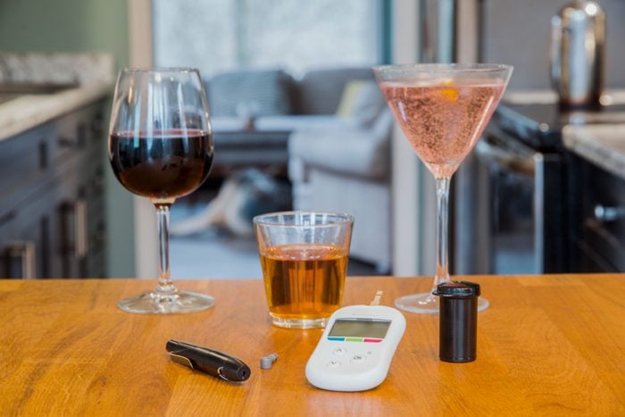 diabetes tools and alcoholic drinks on kitchen table