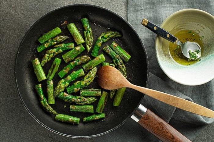 Fresh of green Asparagus. Cooking healthy meal in pan top view- Image