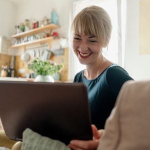 woman on video call with friends and family smiling