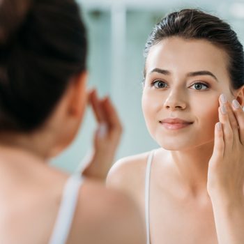 woman mirror face wrinkle cream