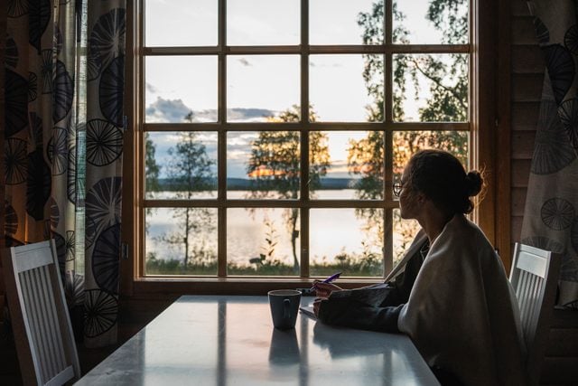 woman sitting at home looking out the window