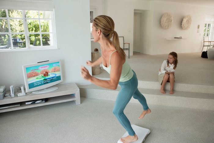 woman playing exercise video game on tv