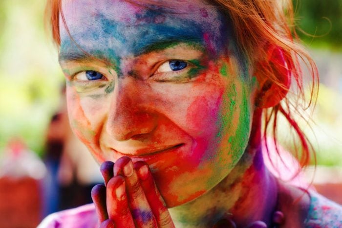 holi festival woman with colors on face rainbow