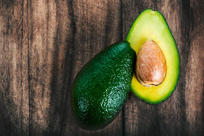 Halved avocado on a wood background