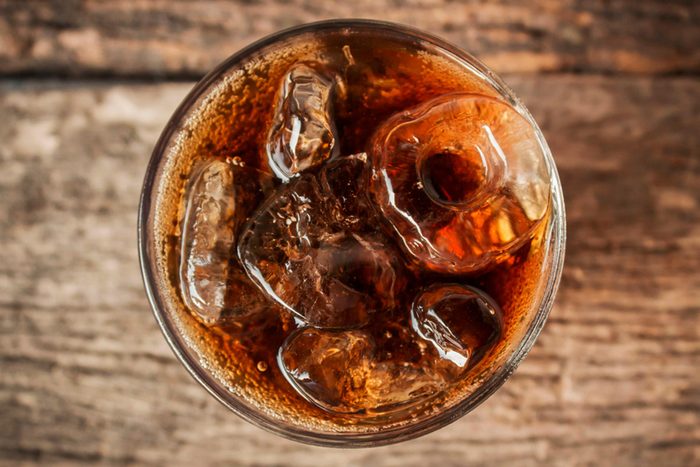Overhead view of glass of cola with ice