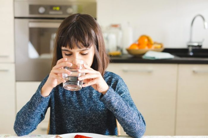 girl drinking glass of water
