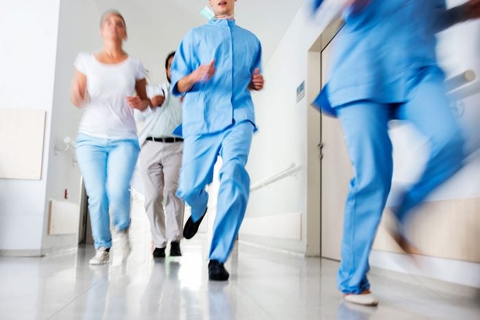 hospital staff running through a hall
