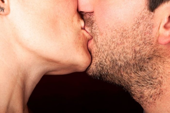close up of a man and woman kissing