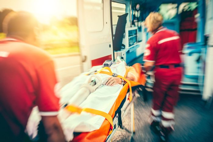 EMTs putting a patent into an ambulence