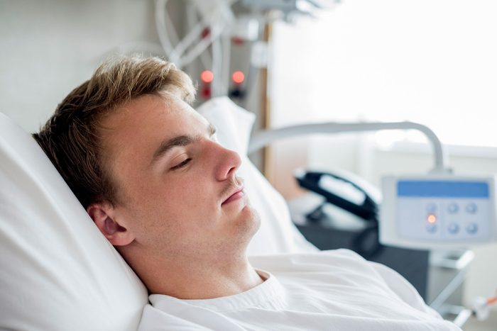 man sleeping in a hospital bed