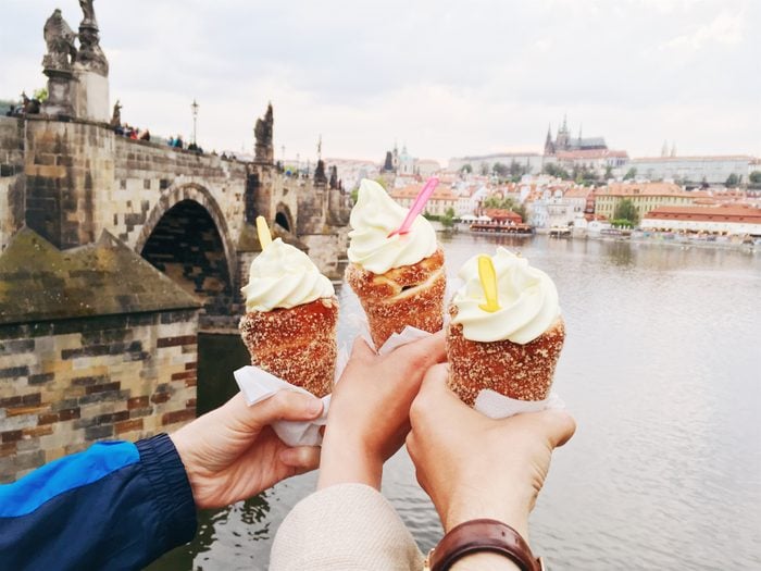 friends holding ice cream cones for social media photo
