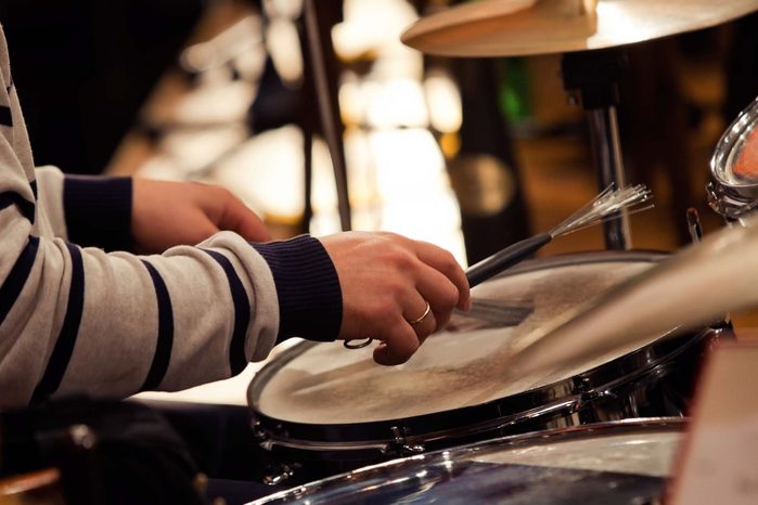 close-up of hands playing the drums