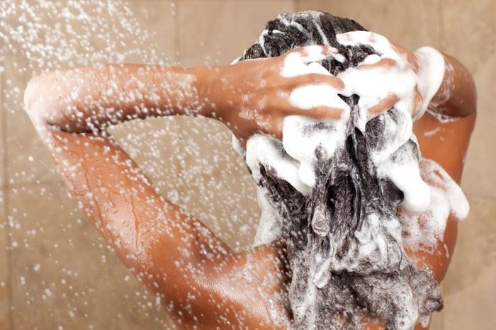 Woman shampooing her hair in the shower.