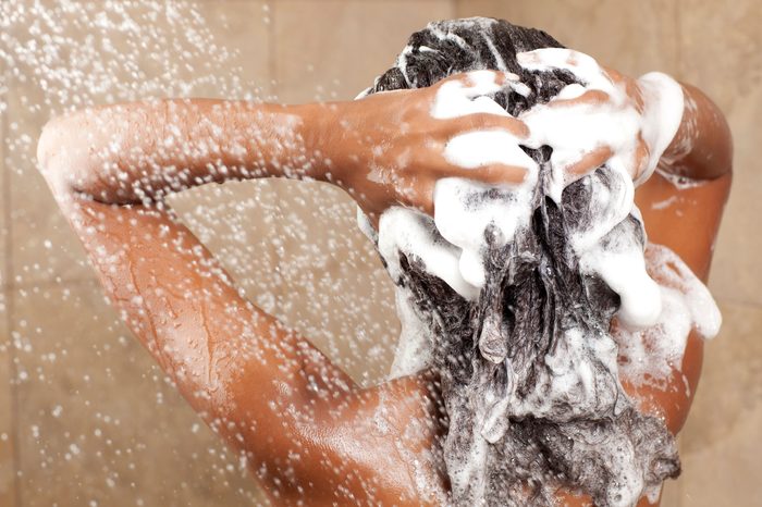 Woman shampooing her hair in the shower.