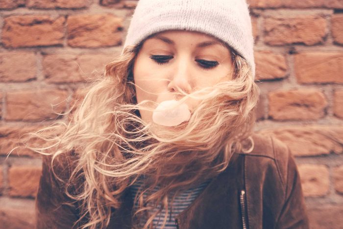 woman blowing a chewing gum bubble