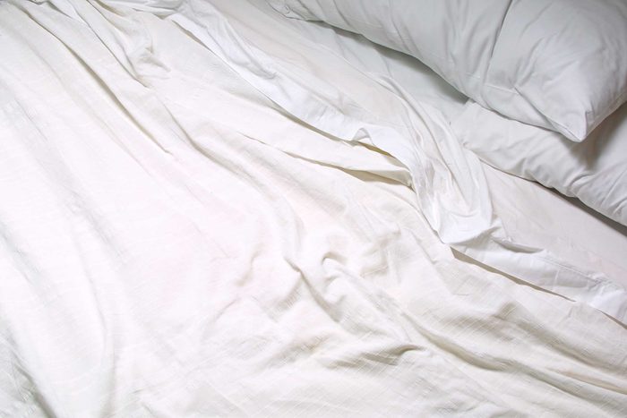 white sheets in unmade bed