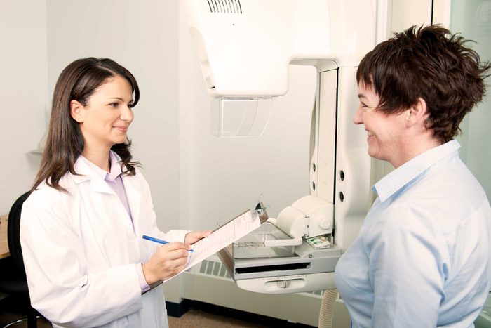 technician and patient consulting before mammogram
