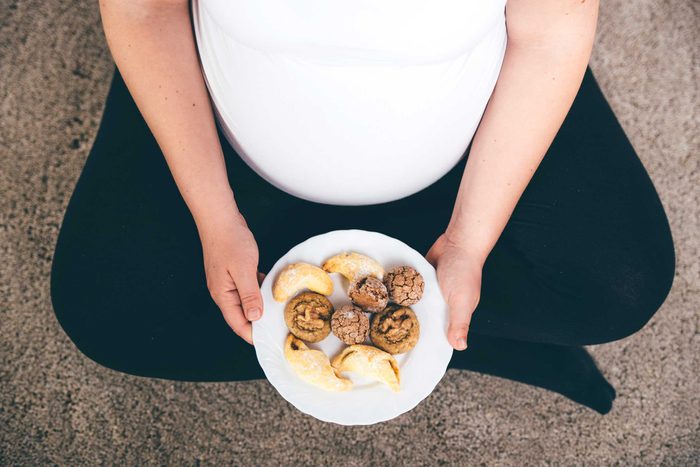 pregnant woman with plate of food