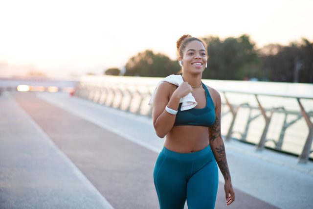 woman walking for exercise and smiling