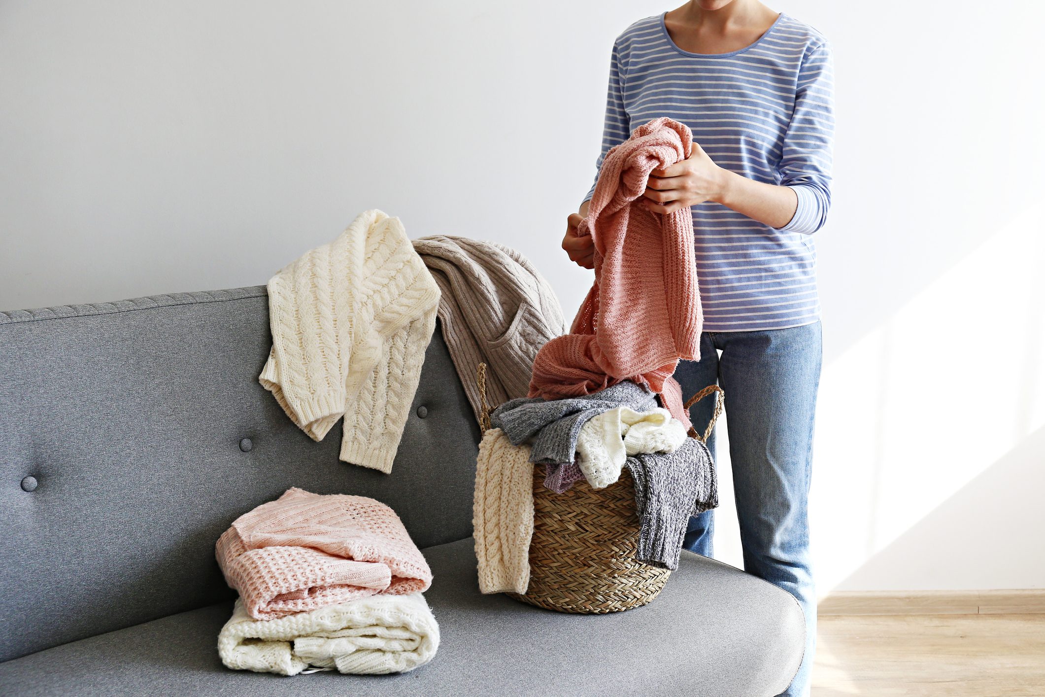 cropped shot of woman organizing laundry