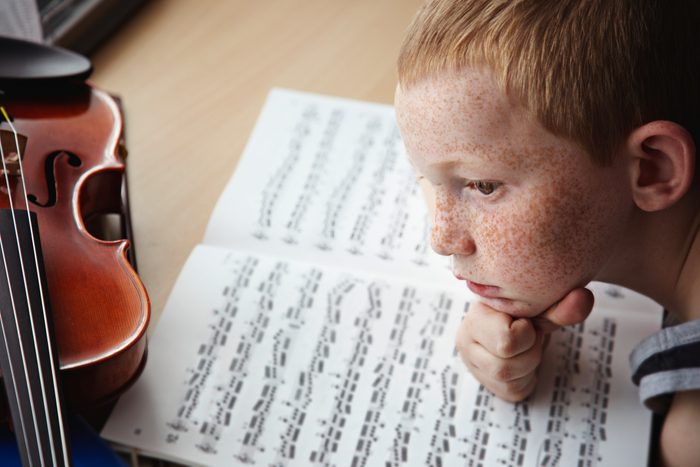 child having trouble focusing on playing instrument