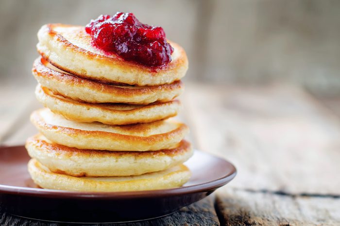 stack of mini pancakes with berry jam on top