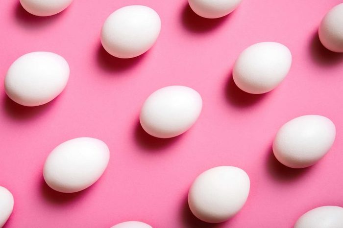 Rows of eggs on a pink background.