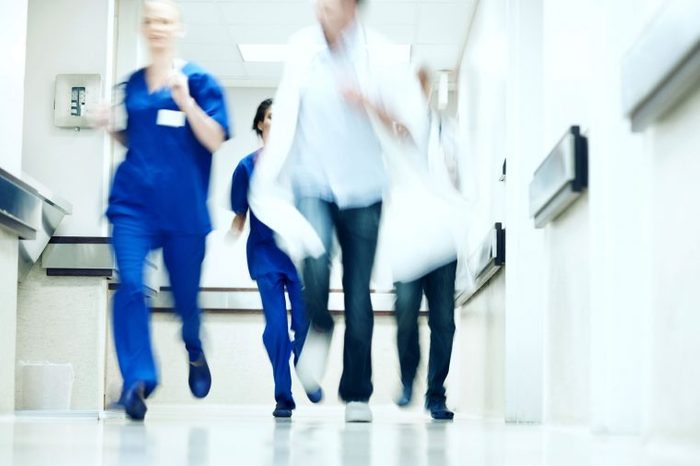 nurses running in hospital corridor