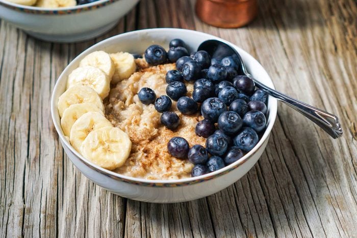 bowl of oats with bananas and blueberries
