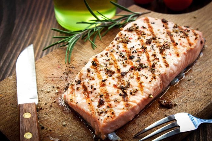 salmon steak on cutting board