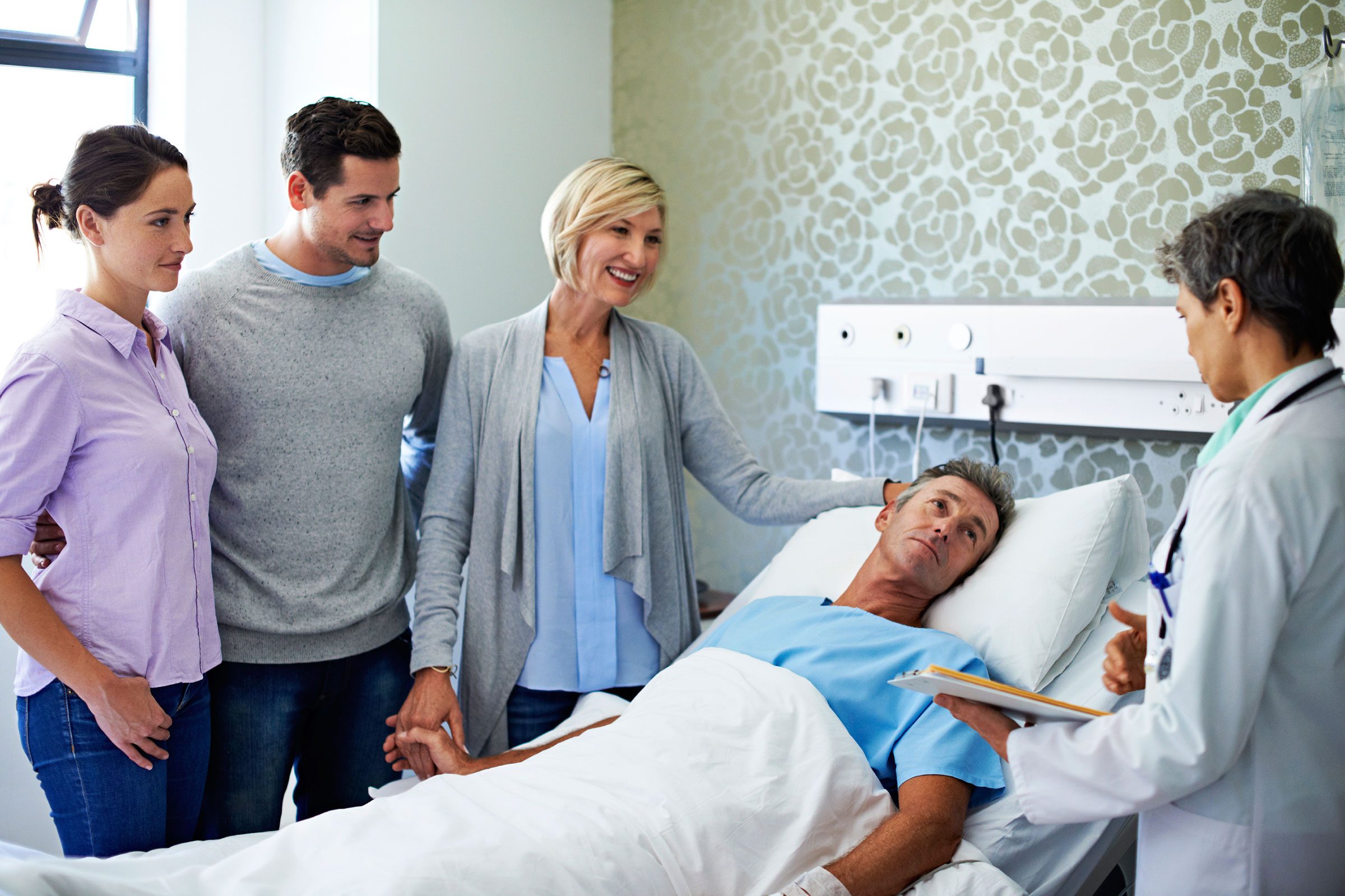 family and doctor at hospital patient's bedside