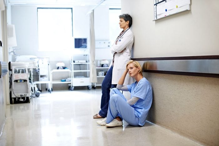 Sad doctors in hospital corridor