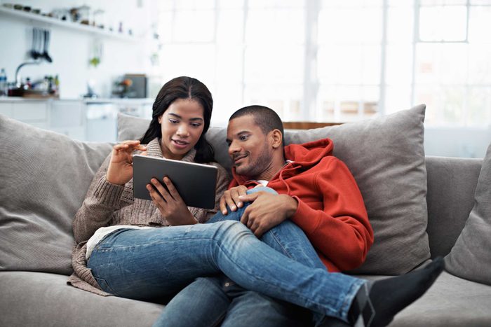 couple on couch with ipad