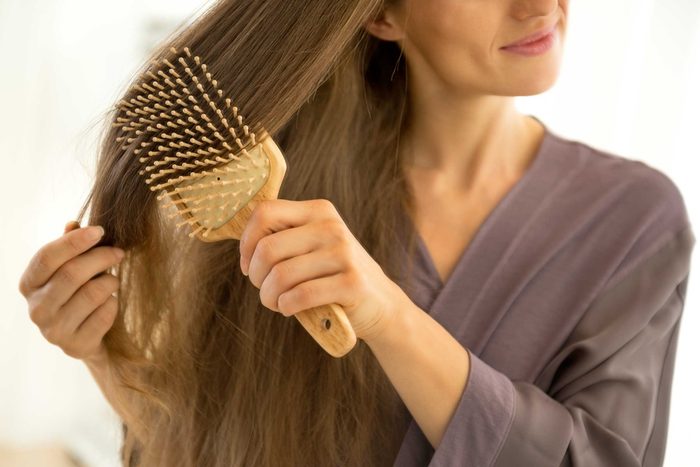 Women brushing her long hair.