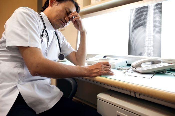 unhappy healthcare worker looking at chest X-ray