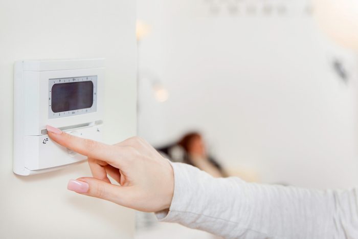 woman changing a thermostat