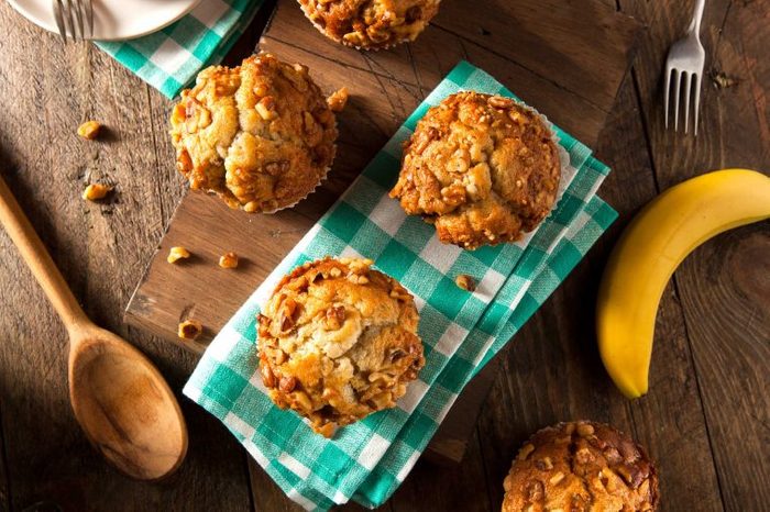 Carb-heavy muffins on a green plaid napkin on a wooden table.