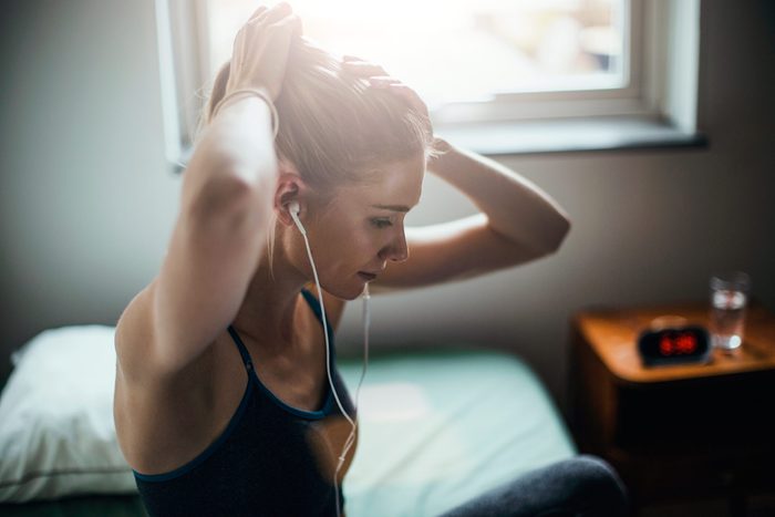 woman in workout gear with earbuds