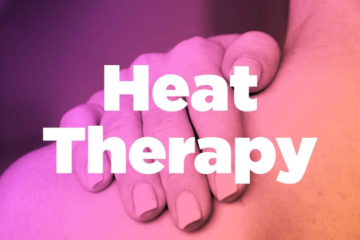 Words "heat therapy" over image of hands rubbing shoulder