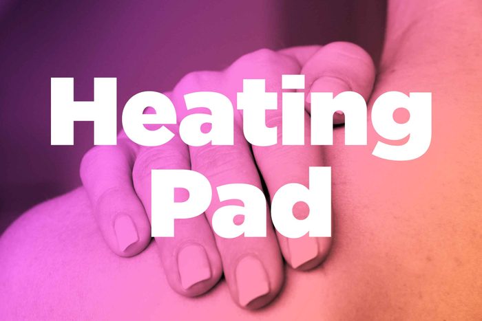 Words "heating pad" over image of hands rubbing shoulder