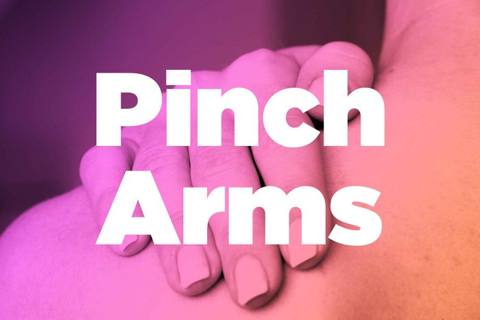 Words "pinch arms" over image of hands rubbing shoulder