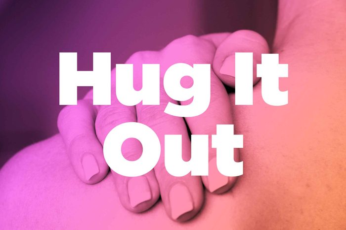 Words "hug it out" over image of hands rubbing shoulder