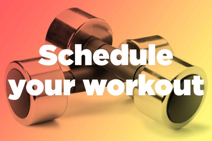 Words "schedule your workout" over hand weights