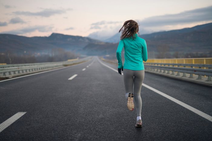 rear view of a woman on a long distance run