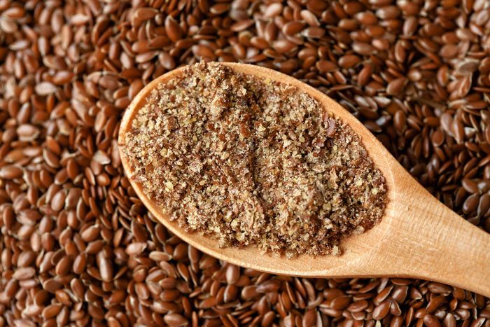 spoonful of ground flaxseed and whole flaxseeds