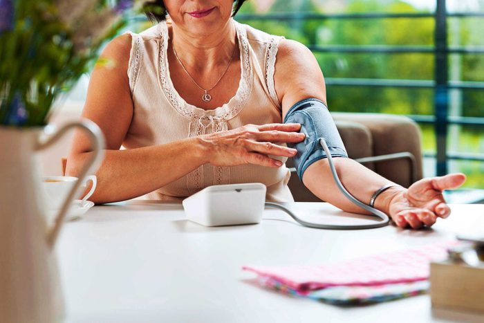 woman taking her own blood pressure