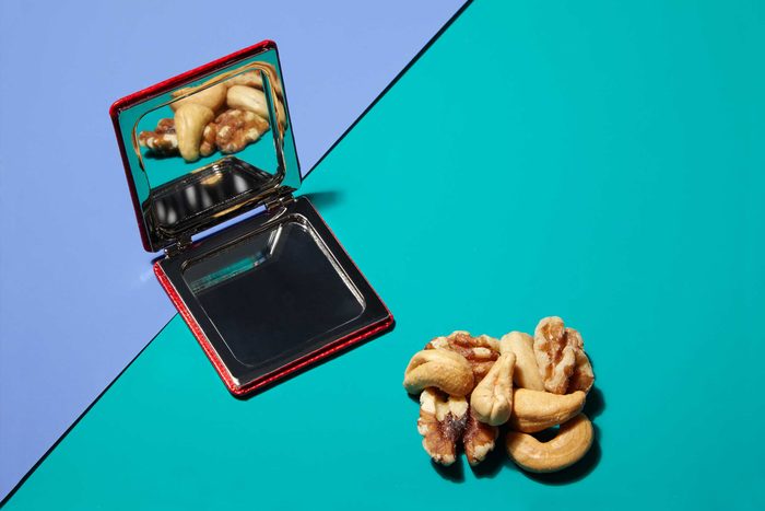 Illustration of portion control trick: compact mirror and mixed nuts