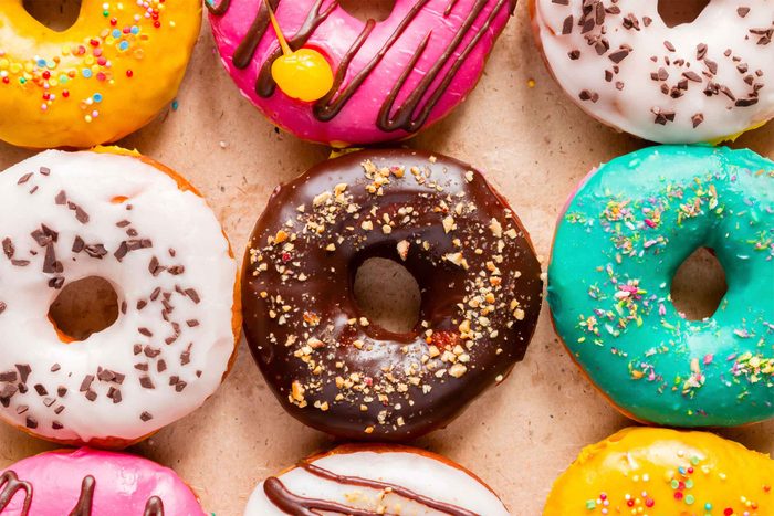 colorfully decorated doughnuts topped with sprinkles and drizzles