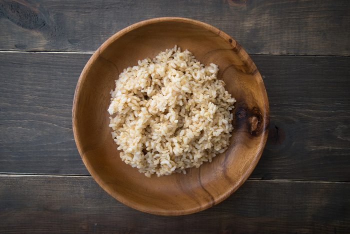 Wooden bowl of brown rice.