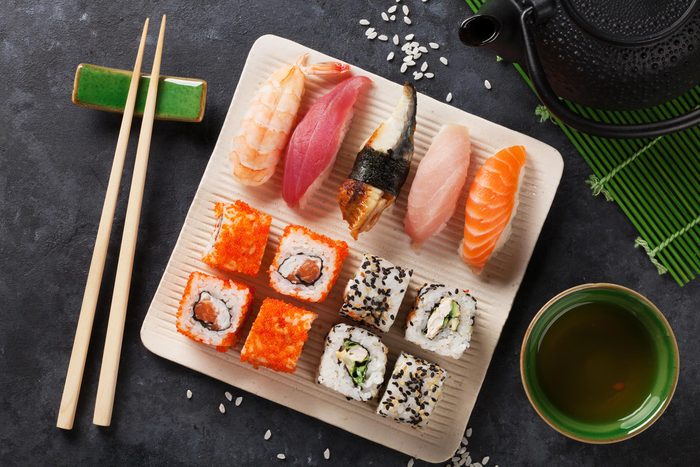 Plate of sushi and sashimi rolls.
